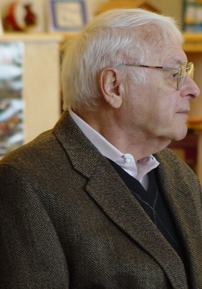 Man wearing coat wearing glasses