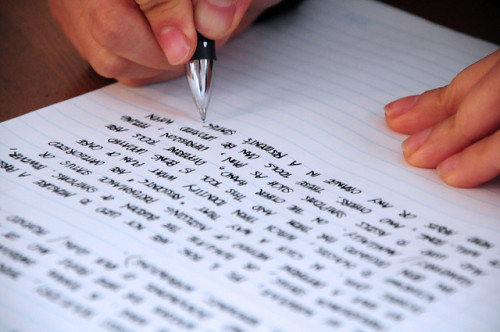 Man writing down on paper