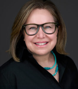Michele Forman smiling wearing glasses
