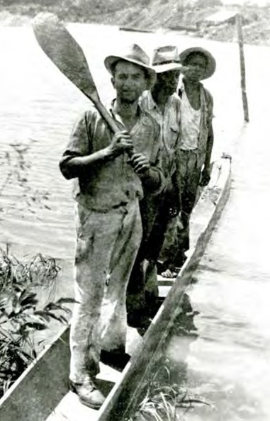 3 men on boat with paddle on rivier