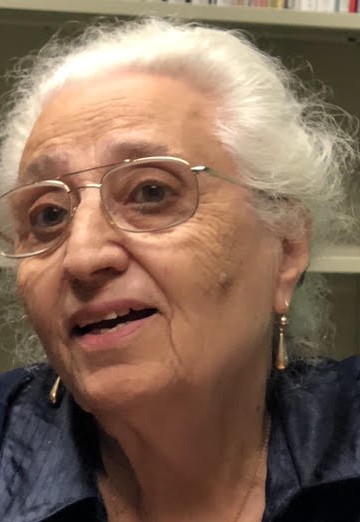 Closeup of woman wearing glasses and earrings