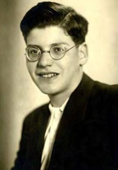 Ernest Kohn smiling photo while wearing circle glasses