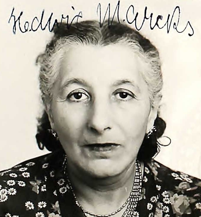 Helga Guttman smiling in photo wearing floral shirt