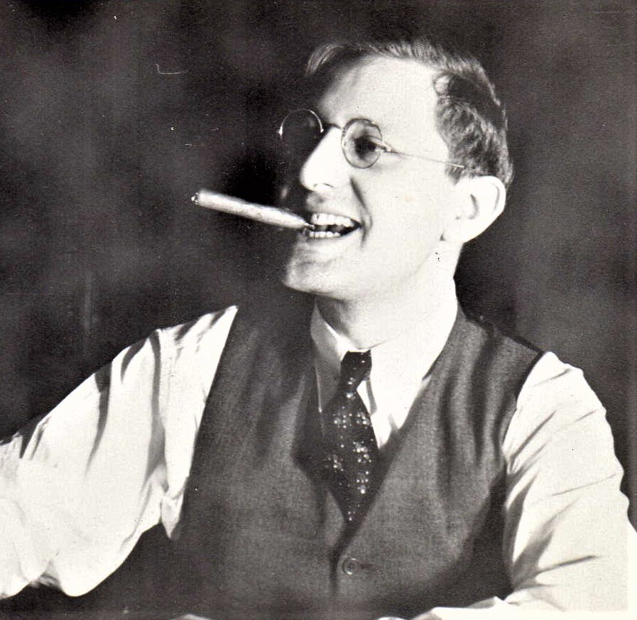 Man wearing vest and tie smoking wearing glasses