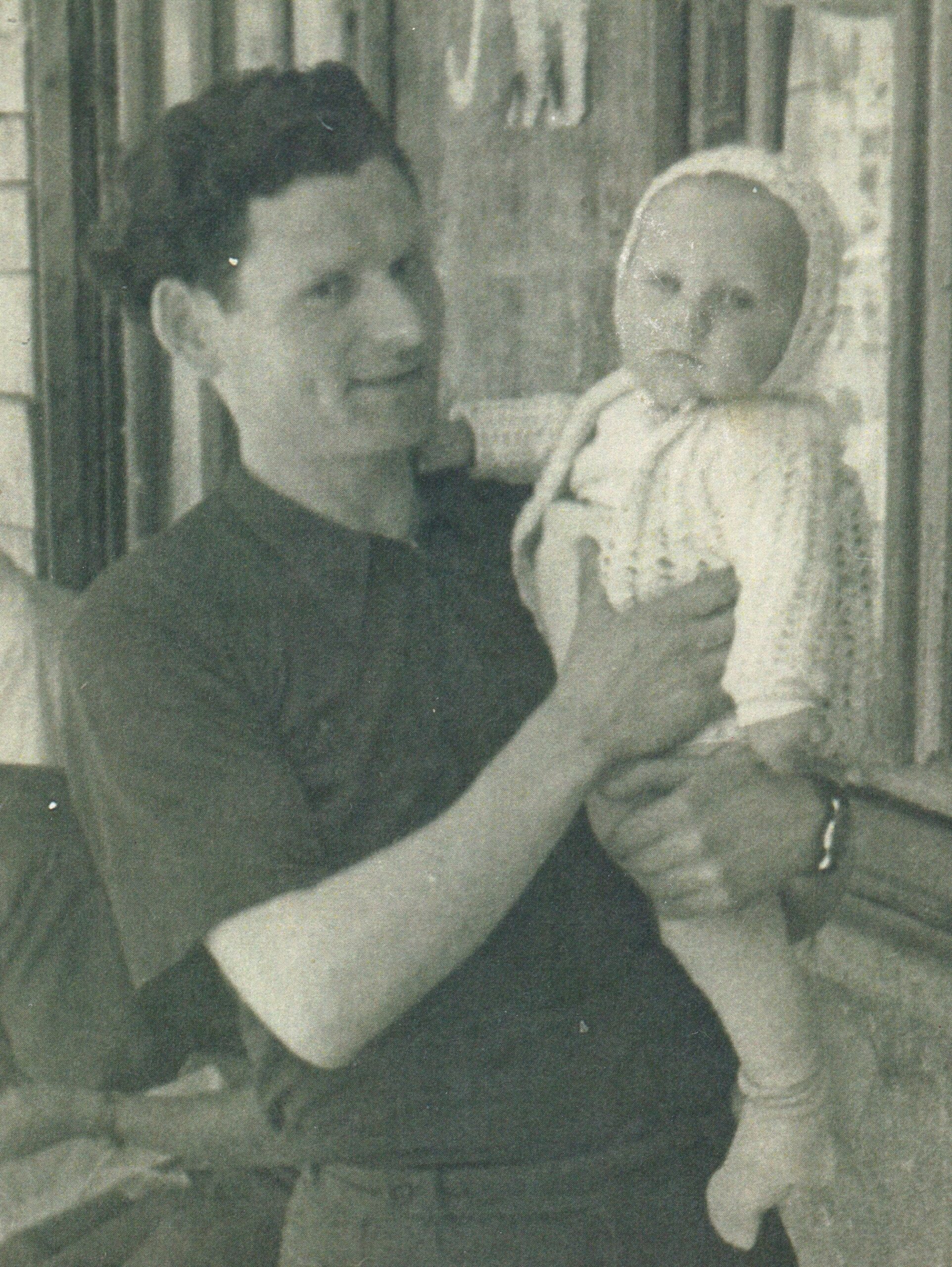 Leon Skurko holding son outside - black and white photo