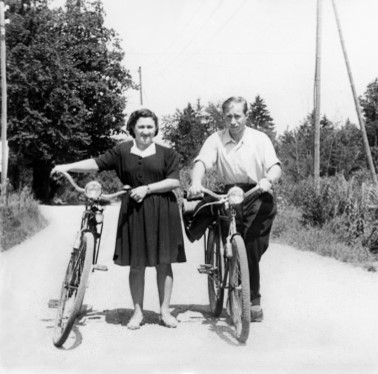 Man and woman outside wearing nice clothes with bikes