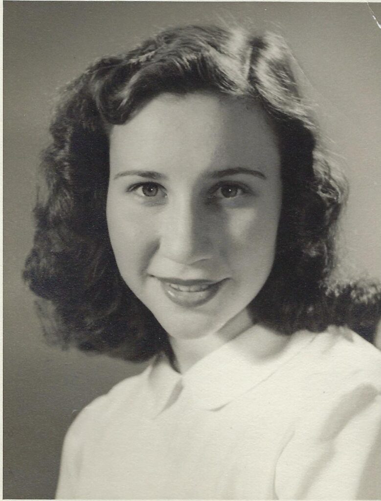 Nelly Urbach smiling posed for photo - black and white