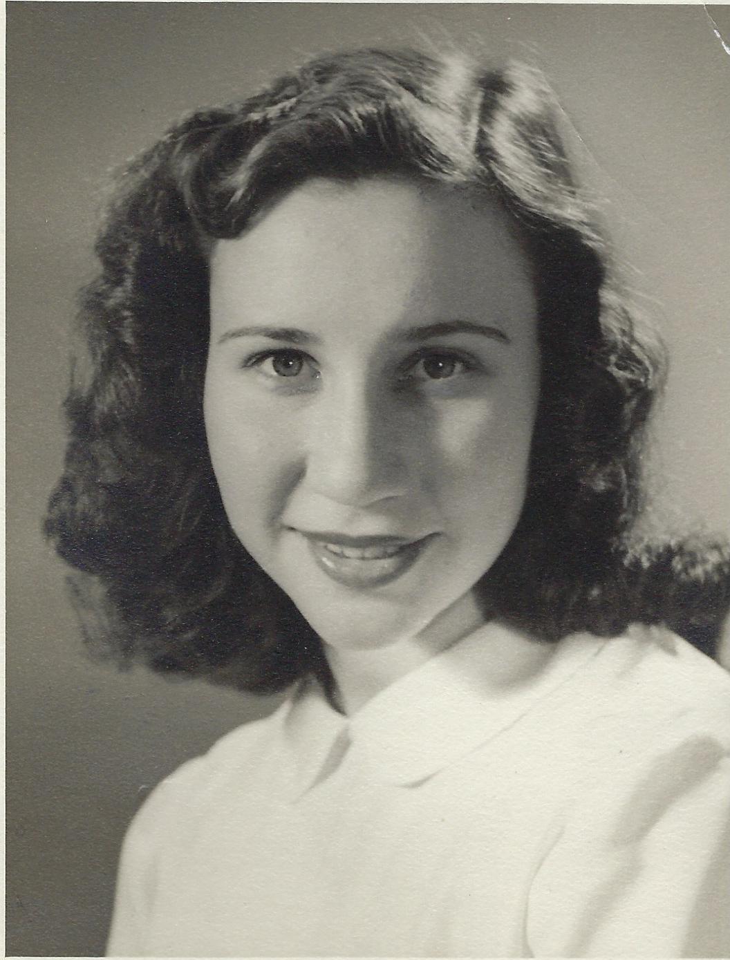 Nelly Urbach smiling posed for photo - black and white