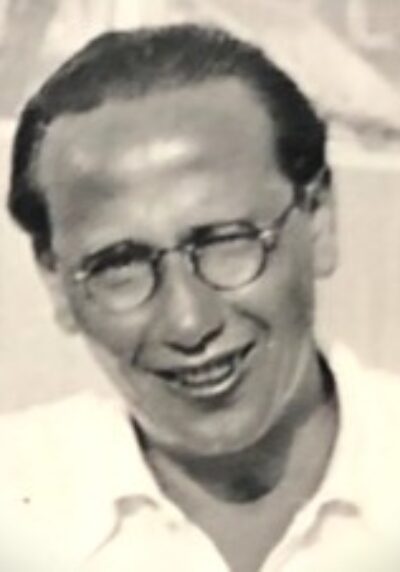 Rabbi Davin smiling wearing glasses outside
