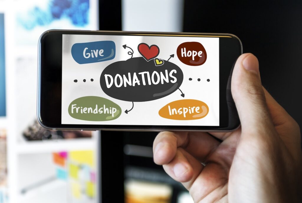 Phone with graphics that say Give, Hope, Friendship, and Inspire